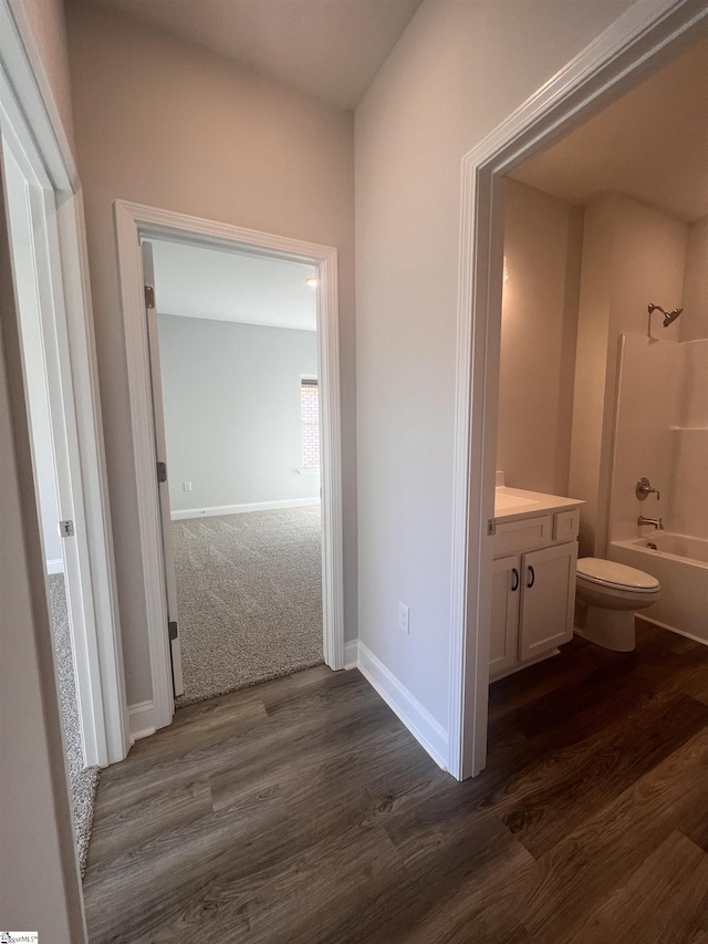 bathroom with shower / bath combination, vanity, toilet, and wood finished floors