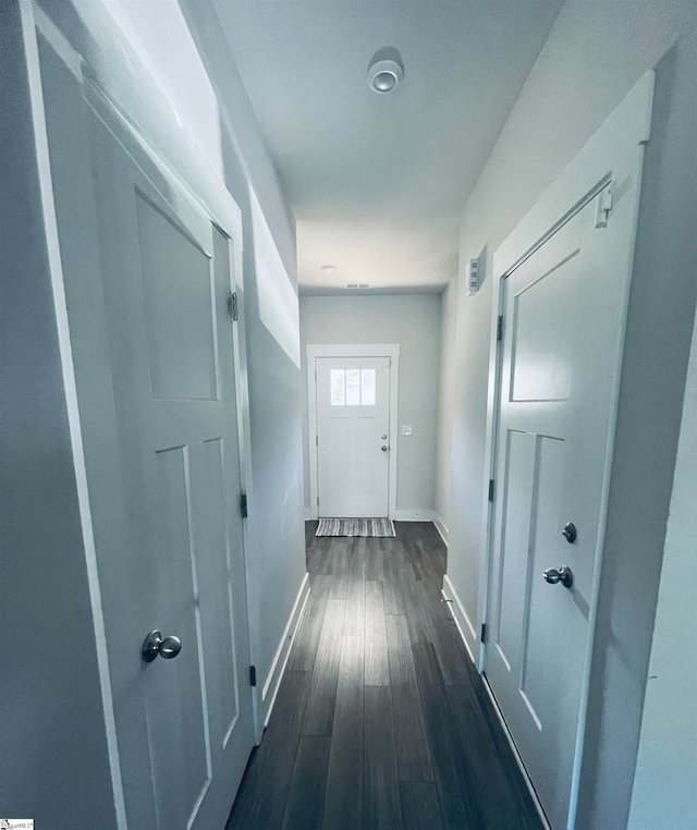 hall with dark hardwood / wood-style floors