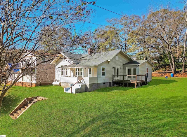 back of property featuring crawl space, roof with shingles, a yard, and a deck