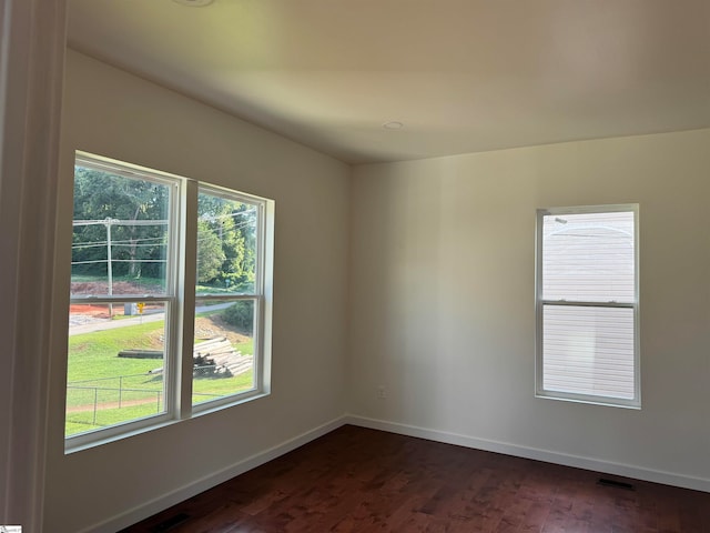 unfurnished room featuring dark hardwood / wood-style floors