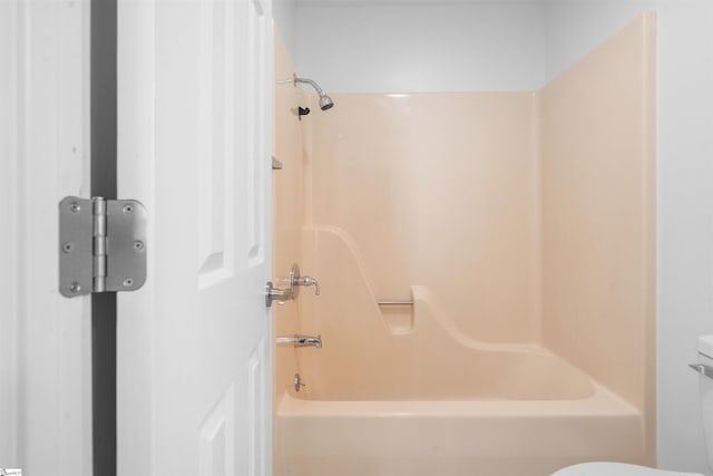 bathroom featuring bathtub / shower combination and toilet