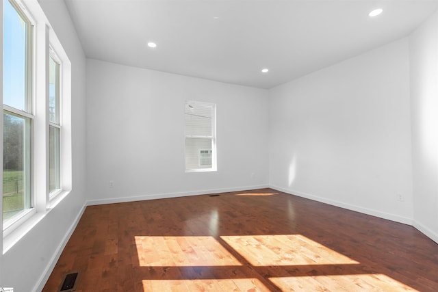 empty room featuring recessed lighting, baseboards, visible vents, and hardwood / wood-style floors