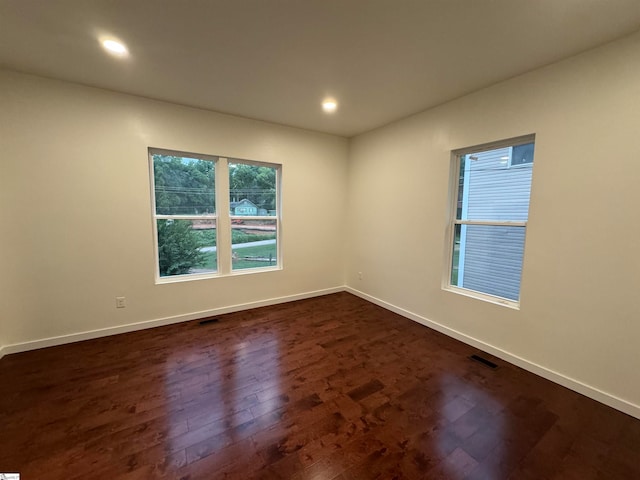 empty room with dark hardwood / wood-style floors