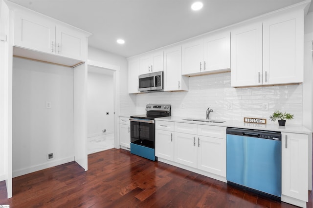 kitchen with decorative backsplash, appliances with stainless steel finishes, light countertops, and a sink