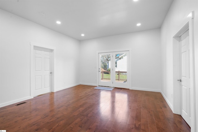 empty room featuring recessed lighting, visible vents, dark wood finished floors, and baseboards