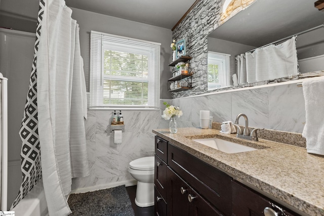 full bathroom with shower / bath combo with shower curtain, tile walls, toilet, and vanity