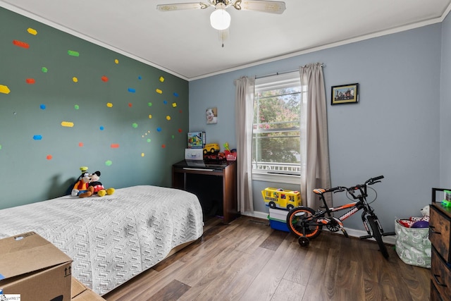 bedroom with ornamental molding, dark wood-type flooring, and ceiling fan