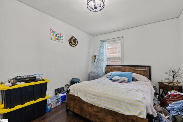 bedroom with dark wood-type flooring