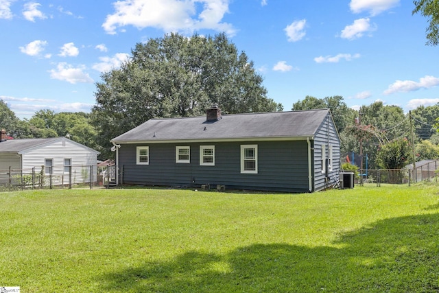 rear view of property with a yard