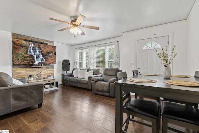 living room featuring ceiling fan, a wealth of natural light, and dark hardwood / wood-style floors