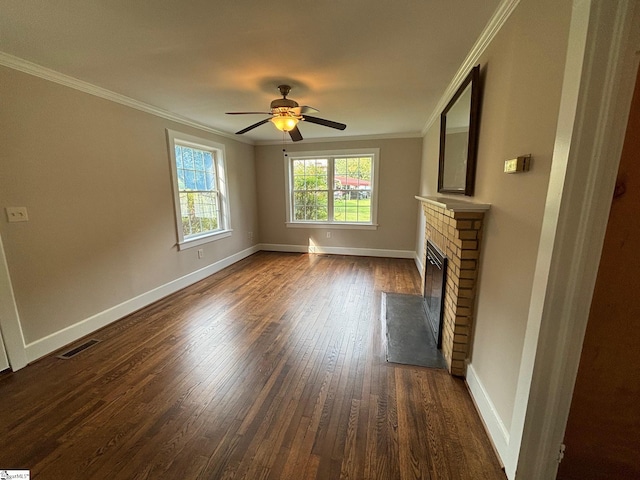 unfurnished living room featuring dark wood-type flooring, crown molding, a fireplace, and ceiling fan