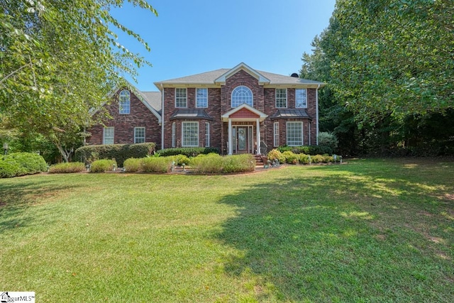 colonial-style house featuring a front lawn