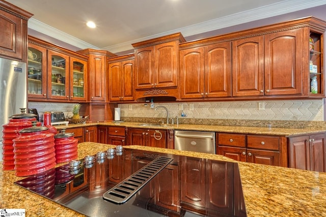 kitchen featuring light stone counters, stainless steel appliances, tasteful backsplash, and sink