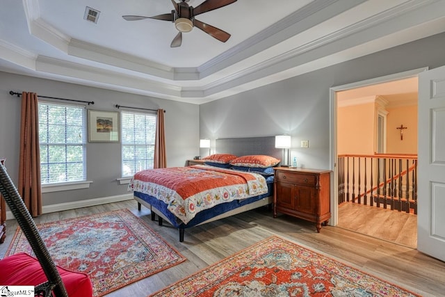 bedroom featuring crown molding, ceiling fan, and light wood-type flooring