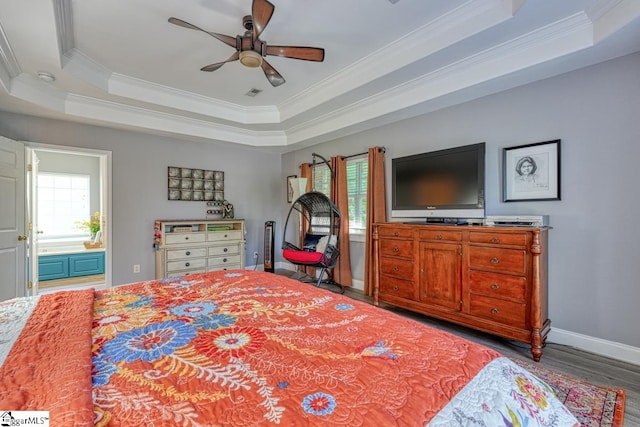 bedroom featuring a tray ceiling, ceiling fan, crown molding, and wood-type flooring