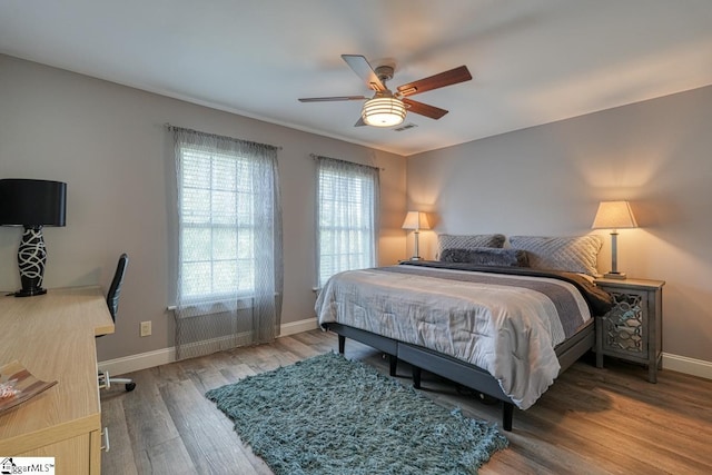 bedroom with hardwood / wood-style flooring and ceiling fan