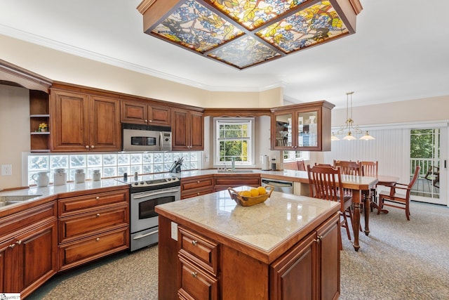 kitchen with tasteful backsplash, crown molding, a kitchen island, appliances with stainless steel finishes, and hanging light fixtures