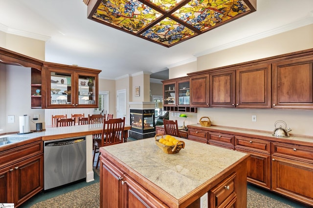 kitchen with dishwasher, a multi sided fireplace, a center island, and crown molding