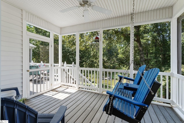 sunroom with a wealth of natural light and ceiling fan