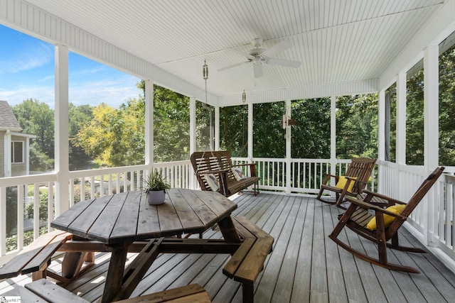 sunroom / solarium featuring ceiling fan