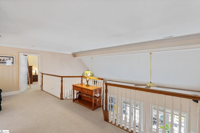 corridor featuring lofted ceiling, light carpet, and crown molding