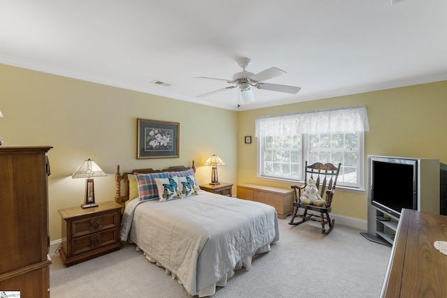 carpeted bedroom featuring ceiling fan and crown molding