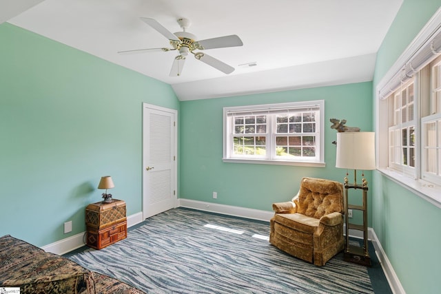 living area with ceiling fan, vaulted ceiling, and carpet floors