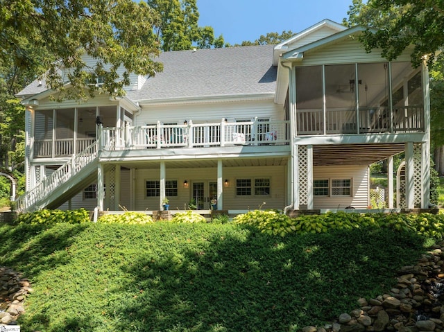 rear view of property with a sunroom