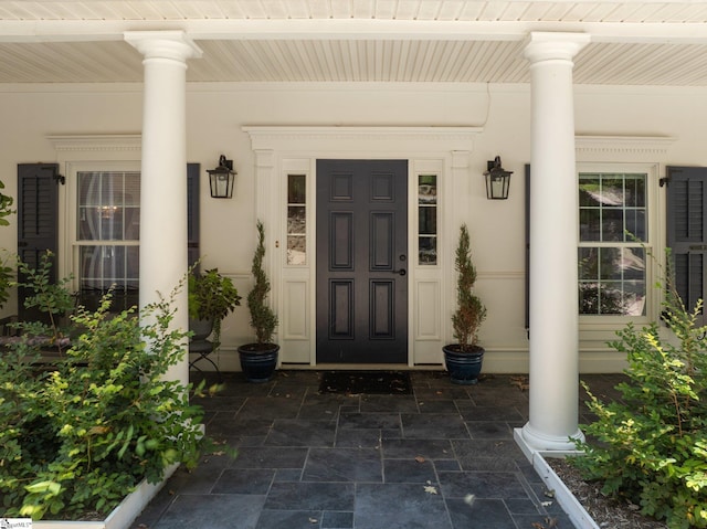 view of exterior entry with covered porch