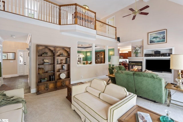 carpeted living room with high vaulted ceiling, a multi sided fireplace, and ceiling fan