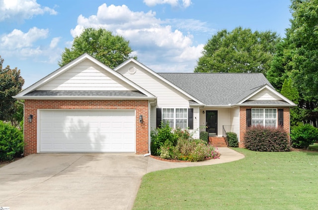 ranch-style house with driveway, roof with shingles, an attached garage, a front yard, and brick siding