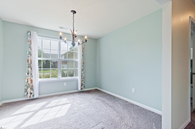 carpeted empty room with baseboards, visible vents, and a chandelier