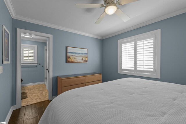 bedroom featuring dark wood-type flooring, ceiling fan, and ornamental molding