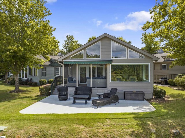 back of house with a yard and a patio