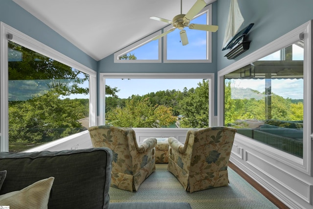 sunroom / solarium featuring ceiling fan, vaulted ceiling, and a healthy amount of sunlight