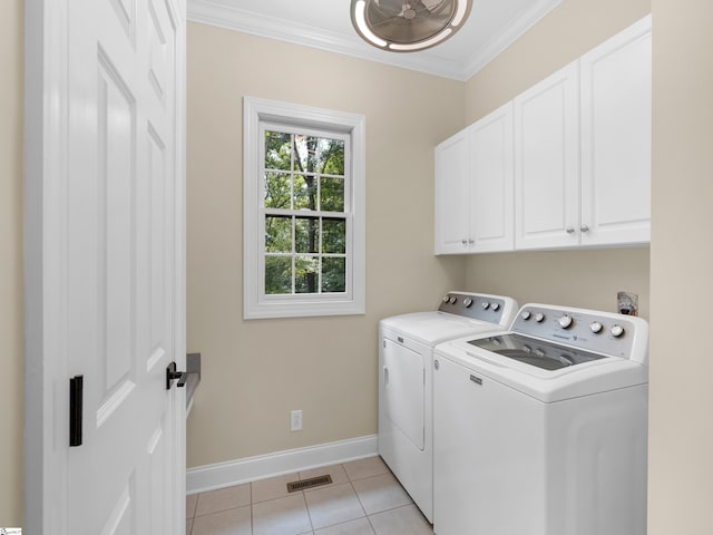 clothes washing area featuring crown molding, cabinets, independent washer and dryer, and light tile patterned flooring