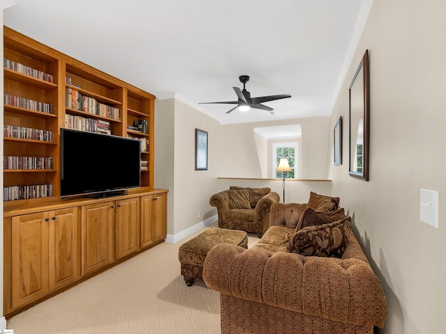 living room with light carpet, ornamental molding, and ceiling fan