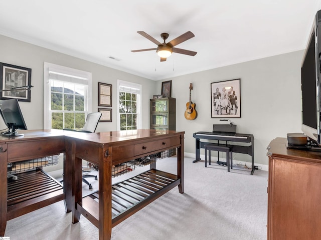 carpeted home office featuring ceiling fan