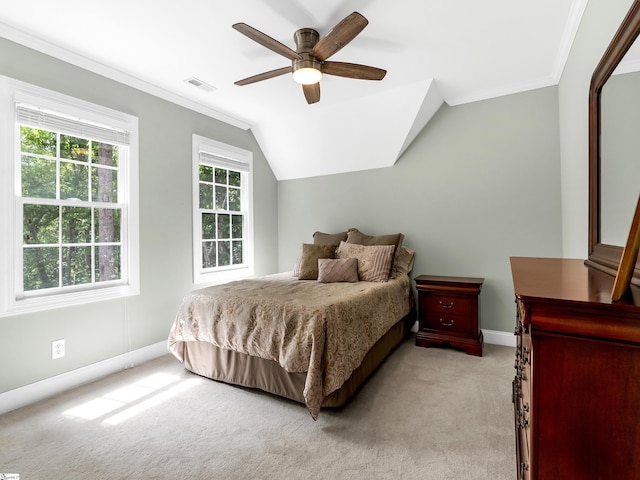 carpeted bedroom featuring lofted ceiling, crown molding, and ceiling fan