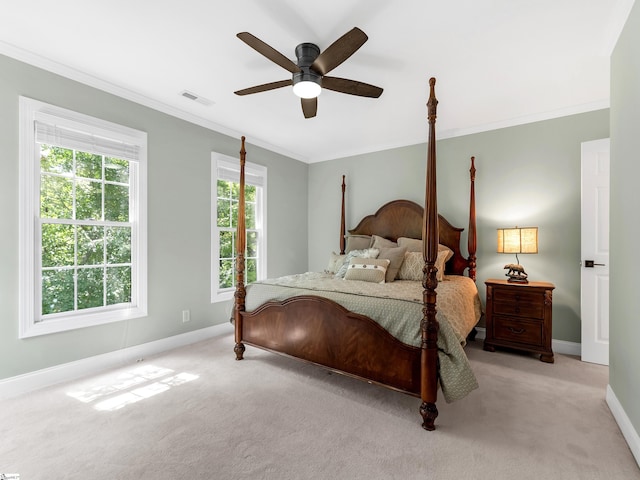 carpeted bedroom featuring crown molding, ceiling fan, and multiple windows