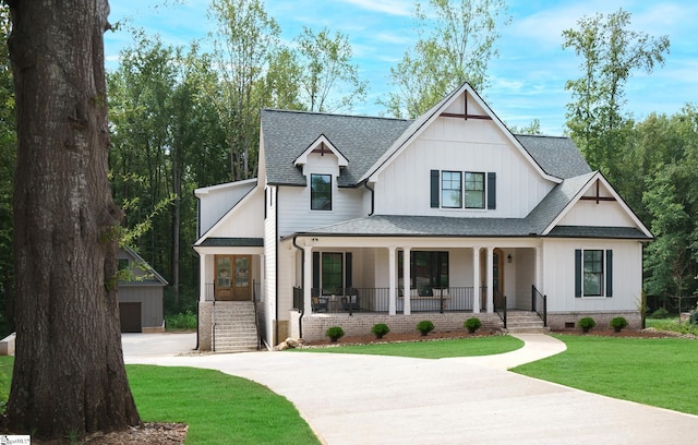 modern farmhouse featuring covered porch and a front yard