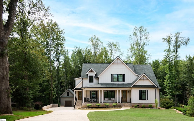 view of front of property with a front lawn, a garage, and a porch