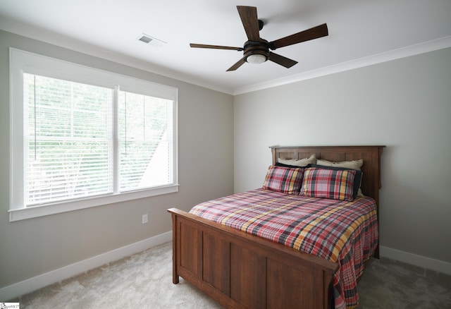 bedroom with light carpet, crown molding, and ceiling fan