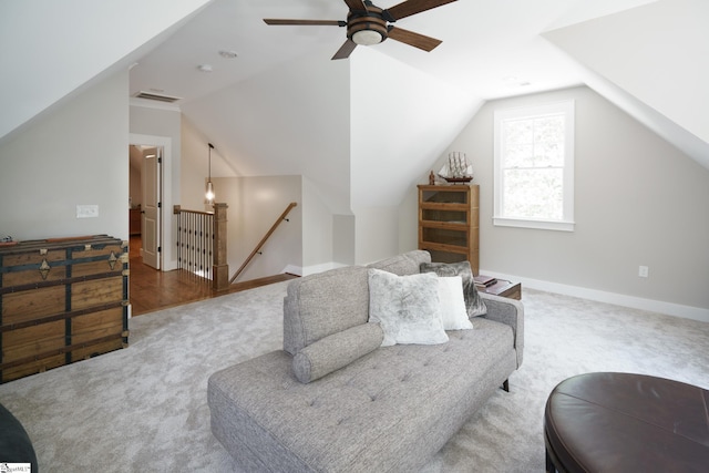 interior space with ceiling fan, carpet, and vaulted ceiling