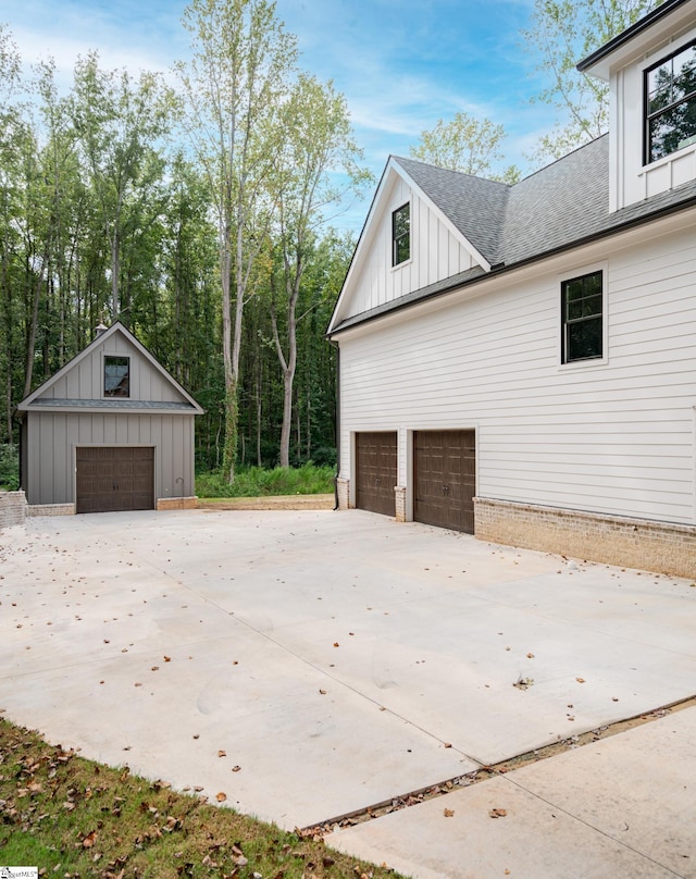 view of side of home with an outdoor structure and a garage