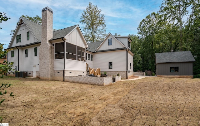 view of property exterior featuring central air condition unit, a storage shed, and a sunroom