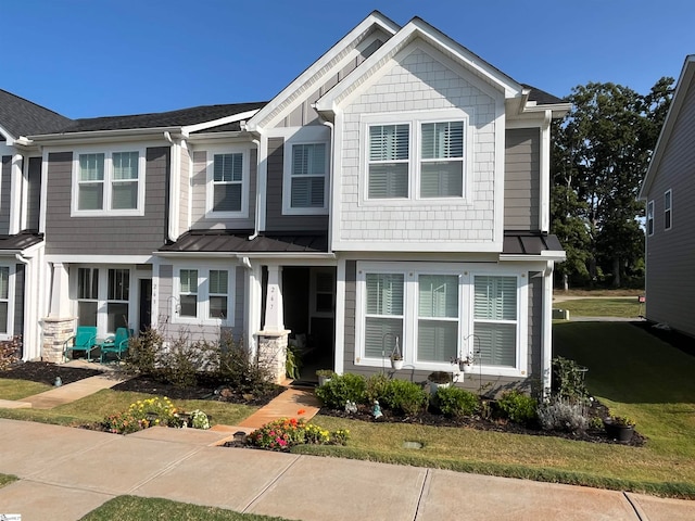 craftsman inspired home with a front lawn