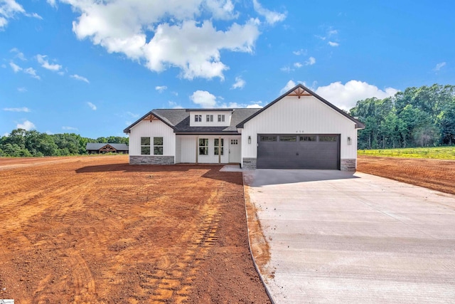 modern farmhouse style home featuring a garage