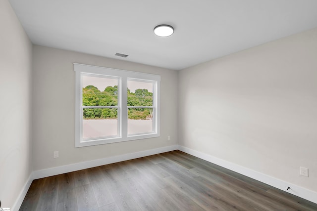 unfurnished room with wood-type flooring