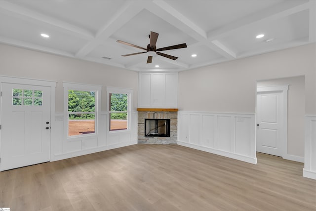 103 Leon Dr, Anderson, SC 29621 - unfurnished living room featuring coffered ceiling, a stone fireplace, light wood-type flooring, a decorative wall, and ceiling fan